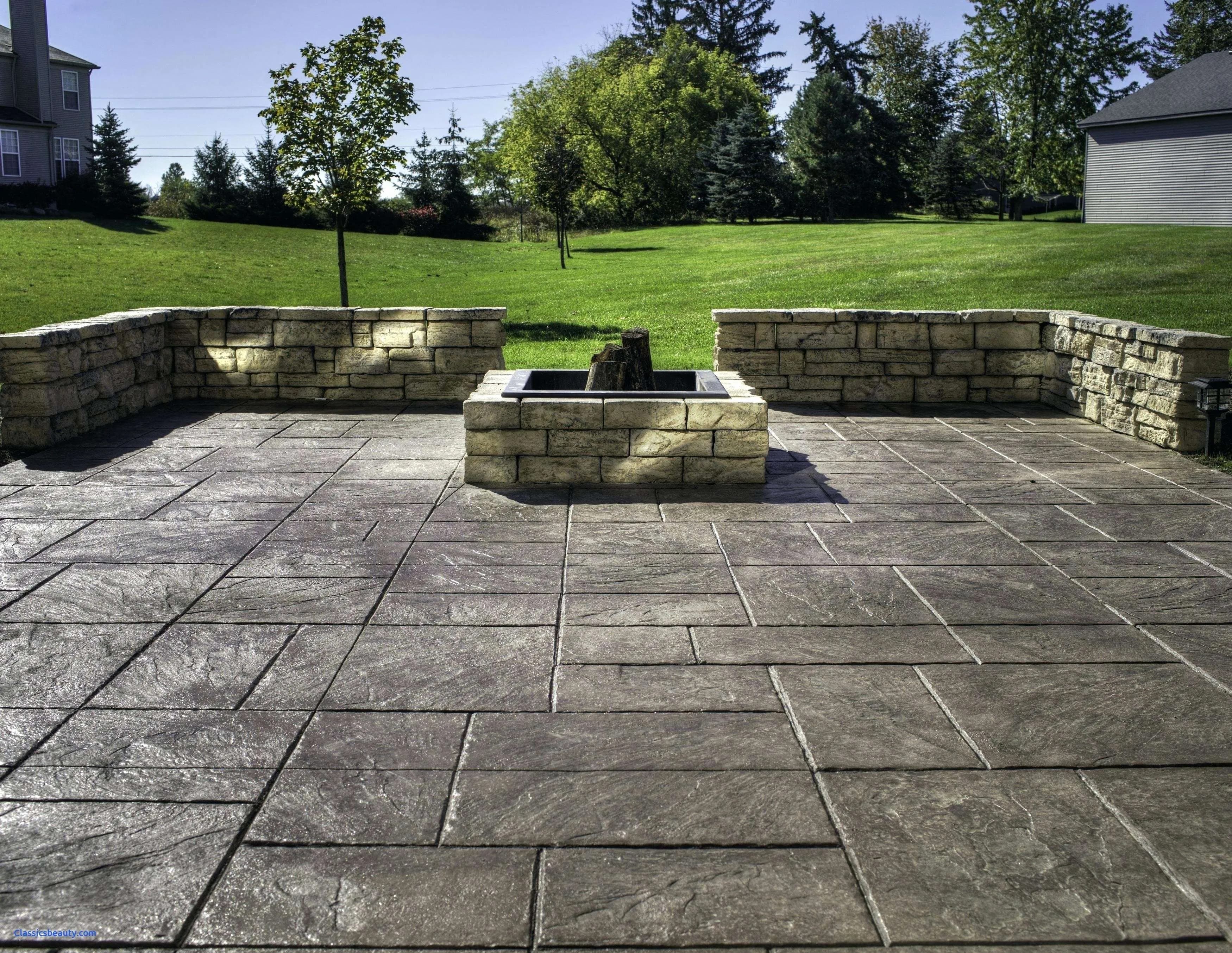 Stamped concrete patio with stone fire pit and retaining walls